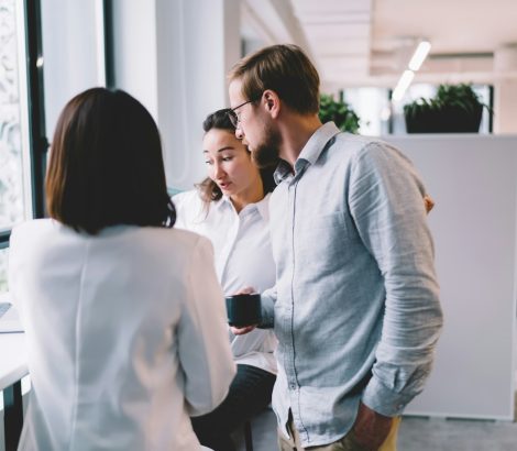 Coworkers talking about work in office